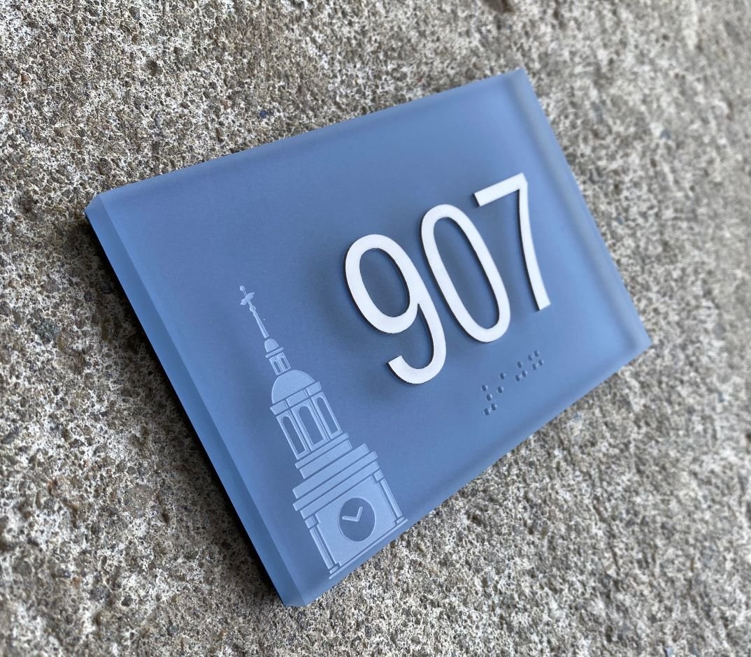 Braille ADA room sign with laser etched logo on thick frosted acrylic