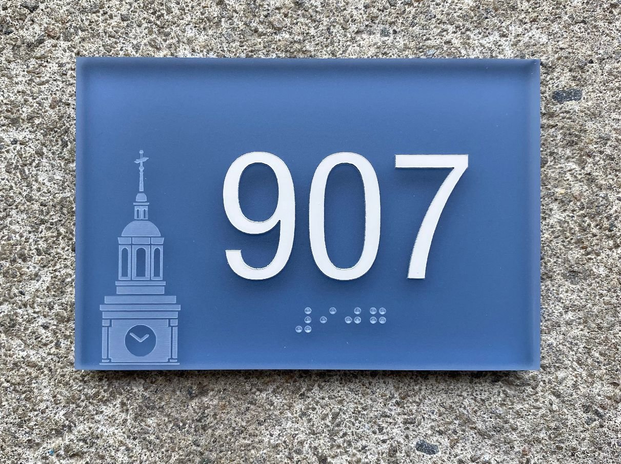 Braille ADA room sign with laser etched logo on thick frosted acrylic