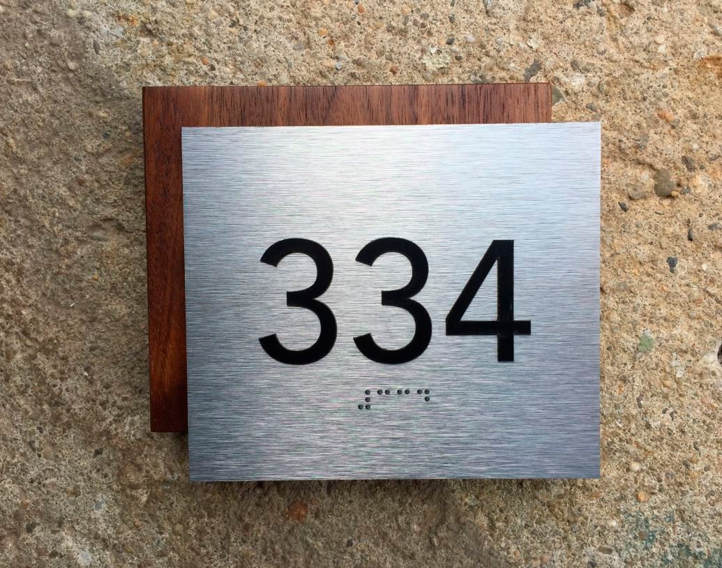 Wood and brushed metal ADA Braille sign
